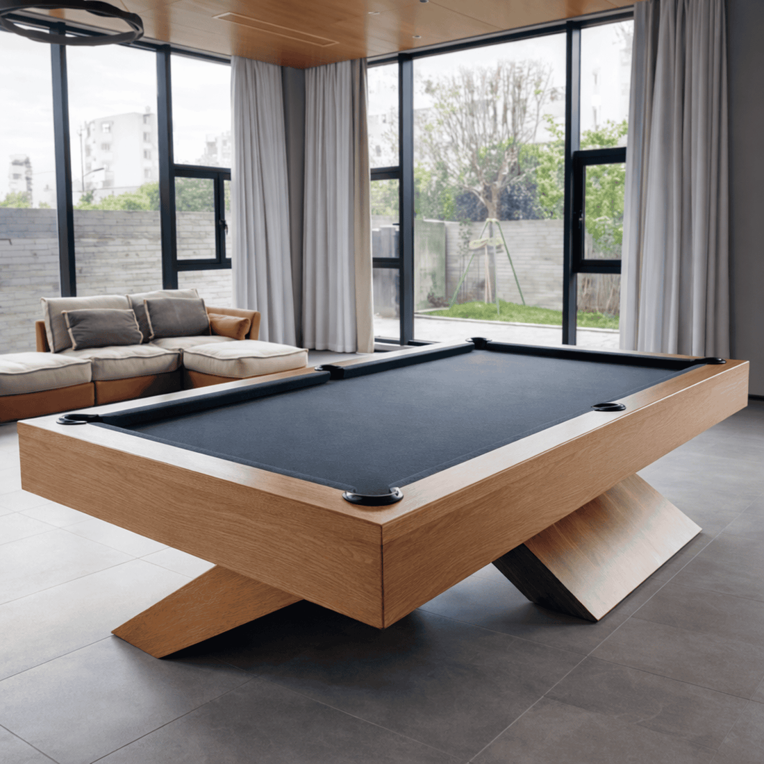 Modern pool table with wooden frame and black felt surface on a white background